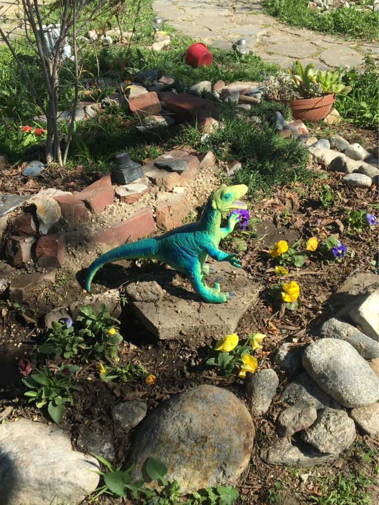dinosaur in a front yard