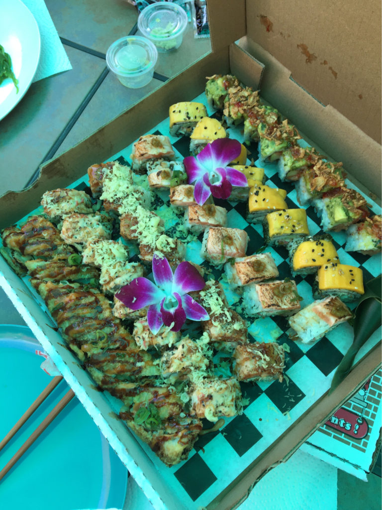 pizza box filled with sushi